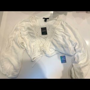 A white boho cropped shirt.